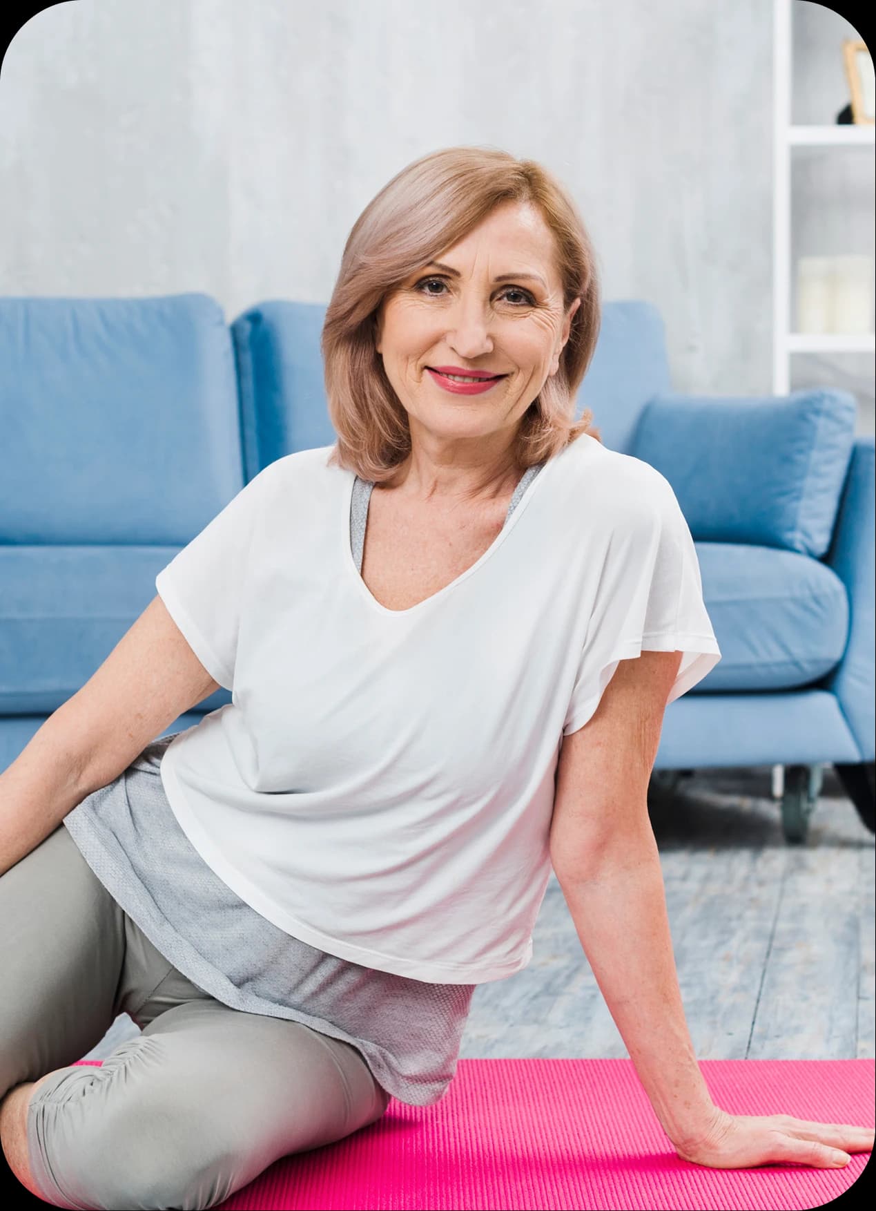 Happy senior woman holding exercise mat