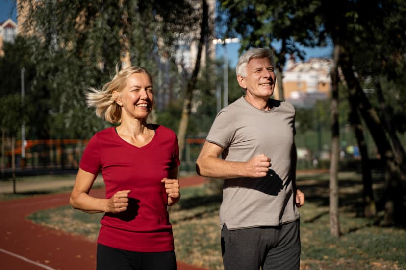 Smiling older couple jogging outdoors